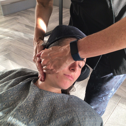 lady in facial chair having a face massage in our london natural skincare shop