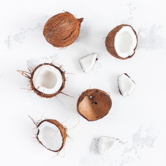 coconut flat lay some whole some broken open