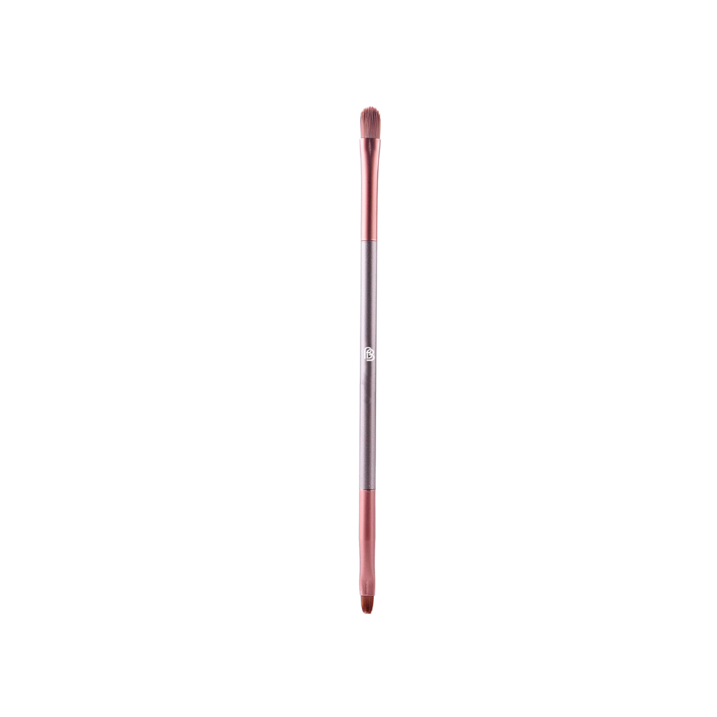 photo of a synthetic cruelty free make up brush in brown, copper and taupe colours. The brush has bristles on both ends. one is a fuller rounder shape for applying lip colour in the centre of the lips or to top up your lipstick throughout the day. The other end is smaller and more compact with a slightly less rounded shape which is good for lipstick touch ups or lining the lips with colour before a full application