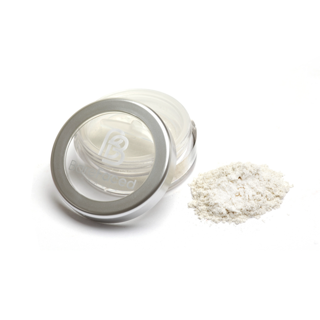 BareFaced Beauty Natural Mineral Shimmer in Golden Goddess. Vegan highlighter makeup. The mineral shimmer is pictured in a plastic jar with a silver lid, and the logo in white on the lid. A pile of the shimmer is sitting next to the pot. The shade is a light golden shimmer