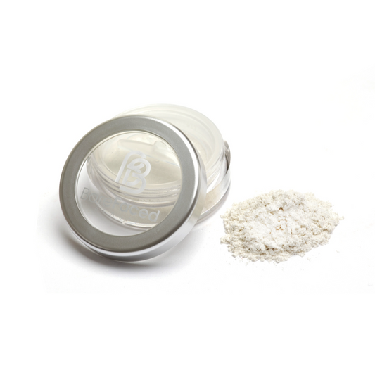 BareFaced Beauty Natural Mineral Shimmer in Golden Goddess. Vegan highlighter makeup. The mineral shimmer is pictured in a plastic jar with a silver lid, and the logo in white on the lid. A pile of the shimmer is sitting next to the pot. The shade is a light golden shimmer