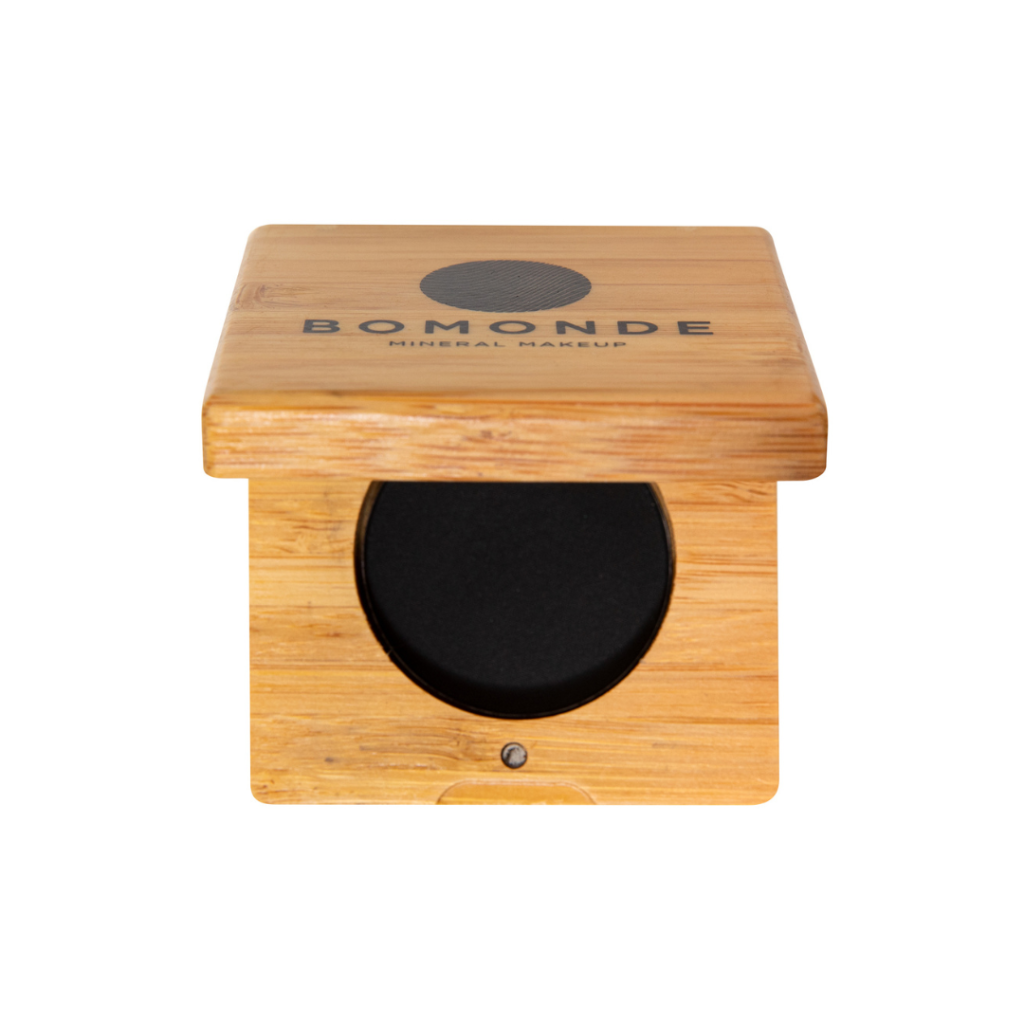 photo of bomonde mineral make up's eyeliner palette. the black eyeliner is pressed into a round pan and encased in a bamboo compact case.