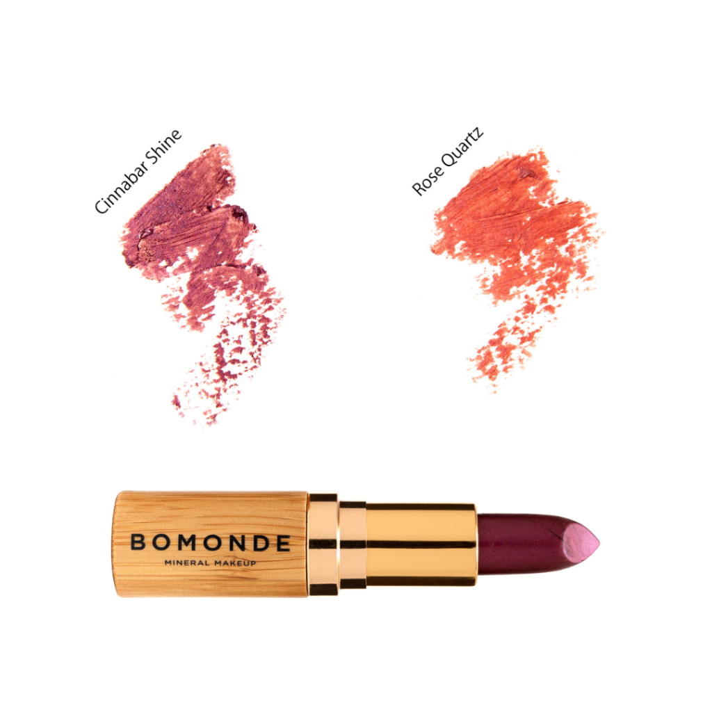Flat lay of Bomonde Natural matte lipstick in the bamboo light brown packaging open and showing the lipstick. 2 colour swatches above. From left to right; Cinnabar Shine (light berry) & Rose Quartz (Peachy/Pink).
