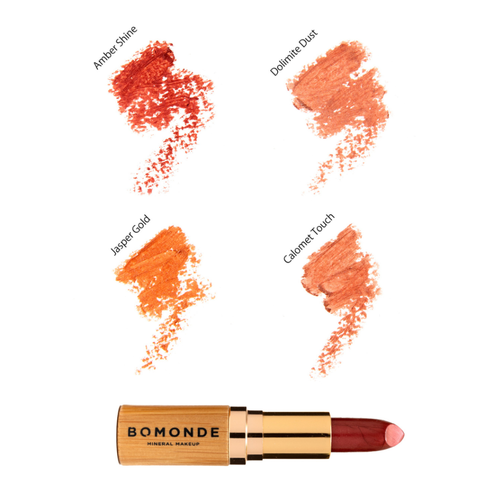 Flat lay of Bomonde Natural Satin lipstick in the bamboo light brown packaging open and showing the lipstick. 4 colour swatches above. Top left to right; Amber Shine & Dolomite Dust. Bottom left to right; Jasper Gold & Calomet Touch.
