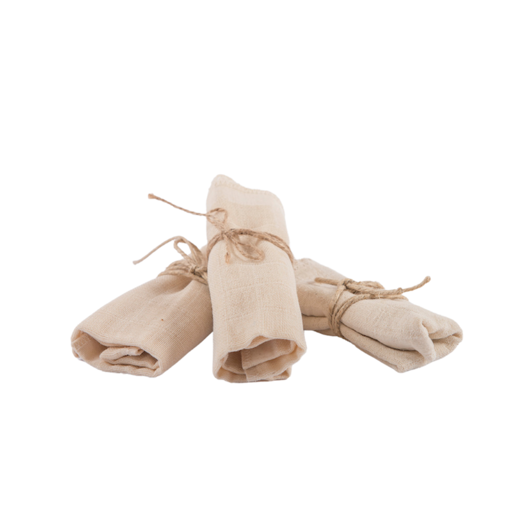 Casa Mencarelli Organic Cotton Face Cloths. Certified organic cotton cloths. The three cotton cloths are pictured rolled up with twine and stacked in a fan shape.