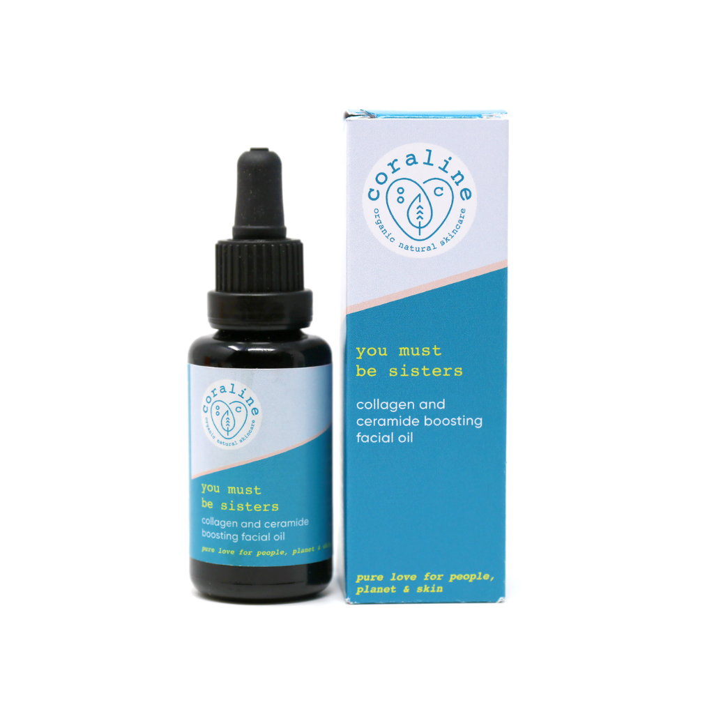 Image of the Coraline Skincare ‘you must be sisters collagen and ceramide boosting’ facial oil. Pictured on a white background the black Miron glass comes with glass pipette. The bottle has a two tone light/mid blue label with yellow and white text. The box packaging is placed next to it and has the same two tone blue colours.