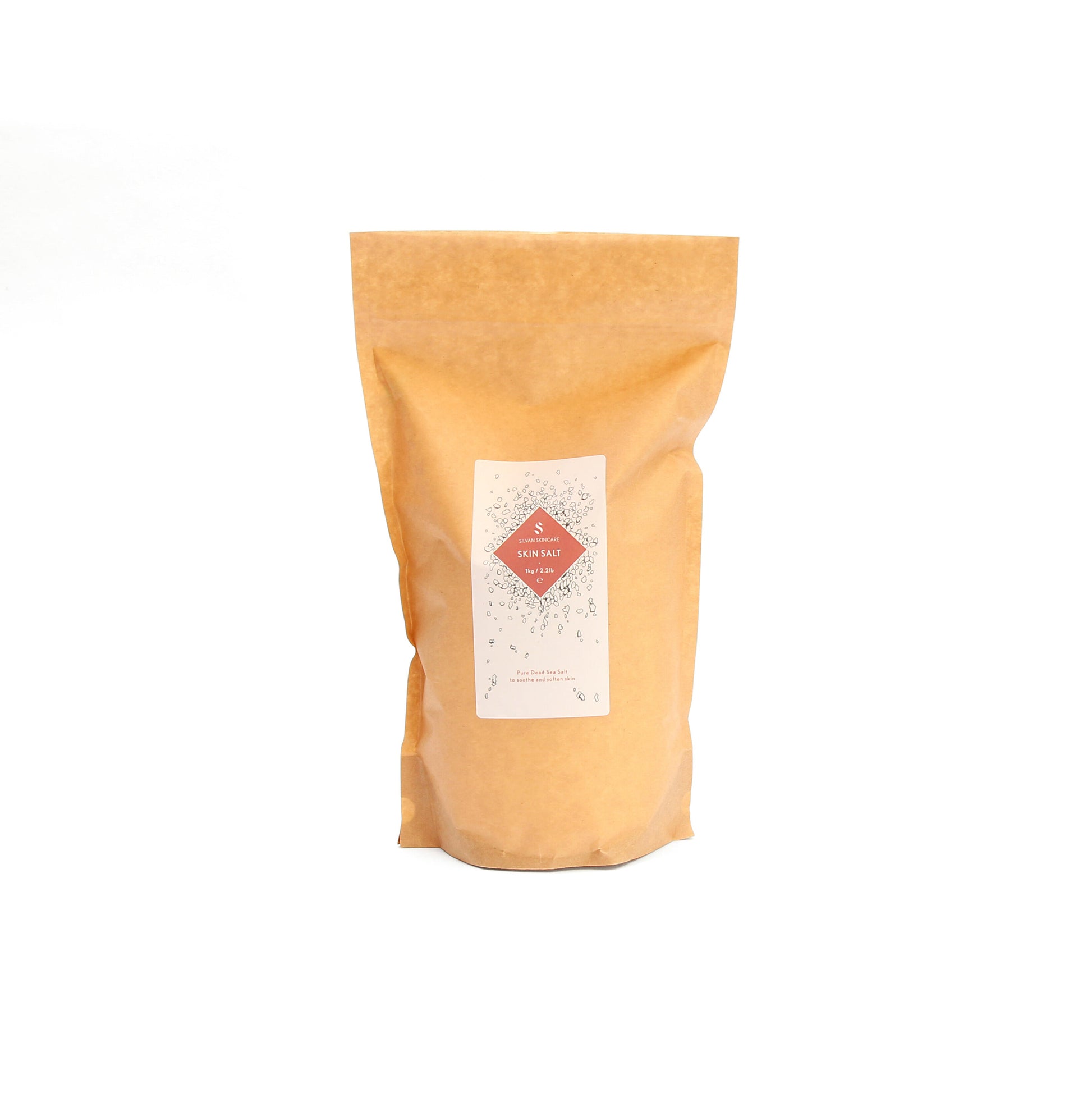A brown bag of the skin salt of the skin salt on a white background. It has a white label and a pink diamond in the middle, listing the product and brand name.