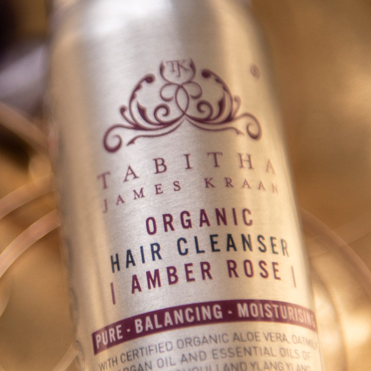 close up photo of tabitha james kraan organic hair cleanser shampoo in amber rose scent