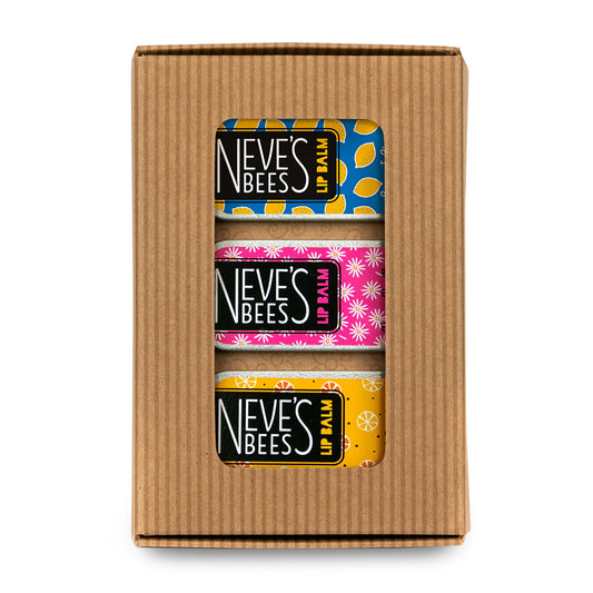 3 colourful rectangular lip balm tins in a brown cardboard window box.