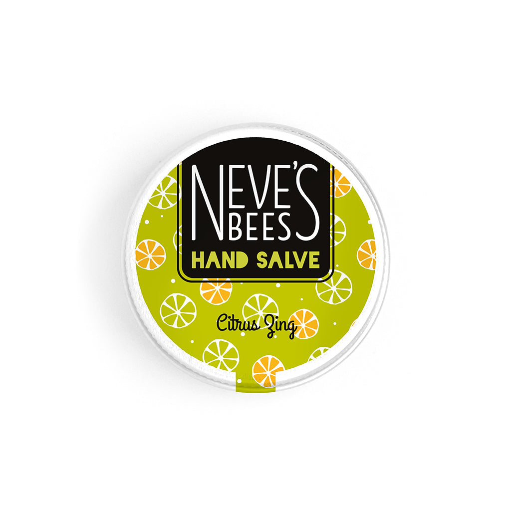 photo of neve's bees hand salve on a white background. the hand salve comes in an aluminium tin with a lime green label on it that reads 'neve's bees hand salve citrus zing' there are graphics of citrus fruit slices in the background of the label.