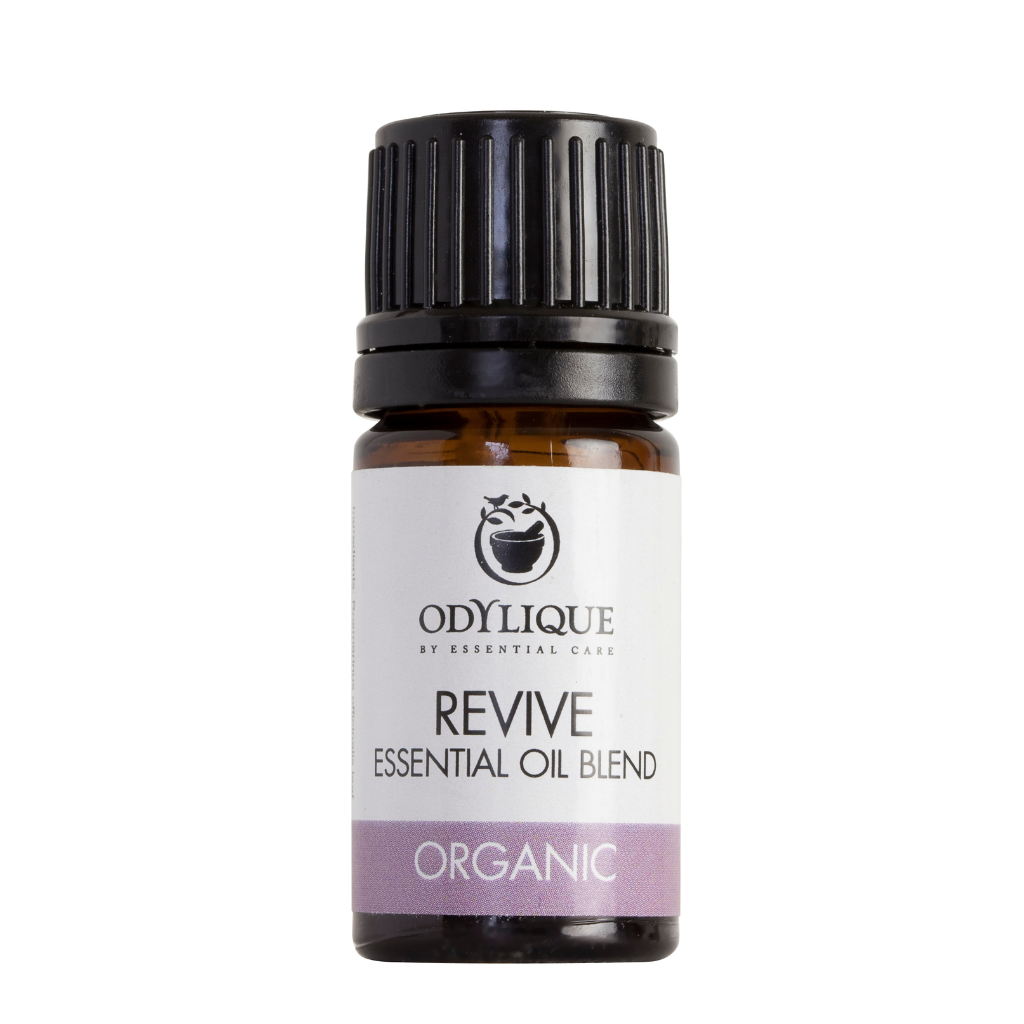 An amber glass dropper bottle of odylique revive essential oil blend