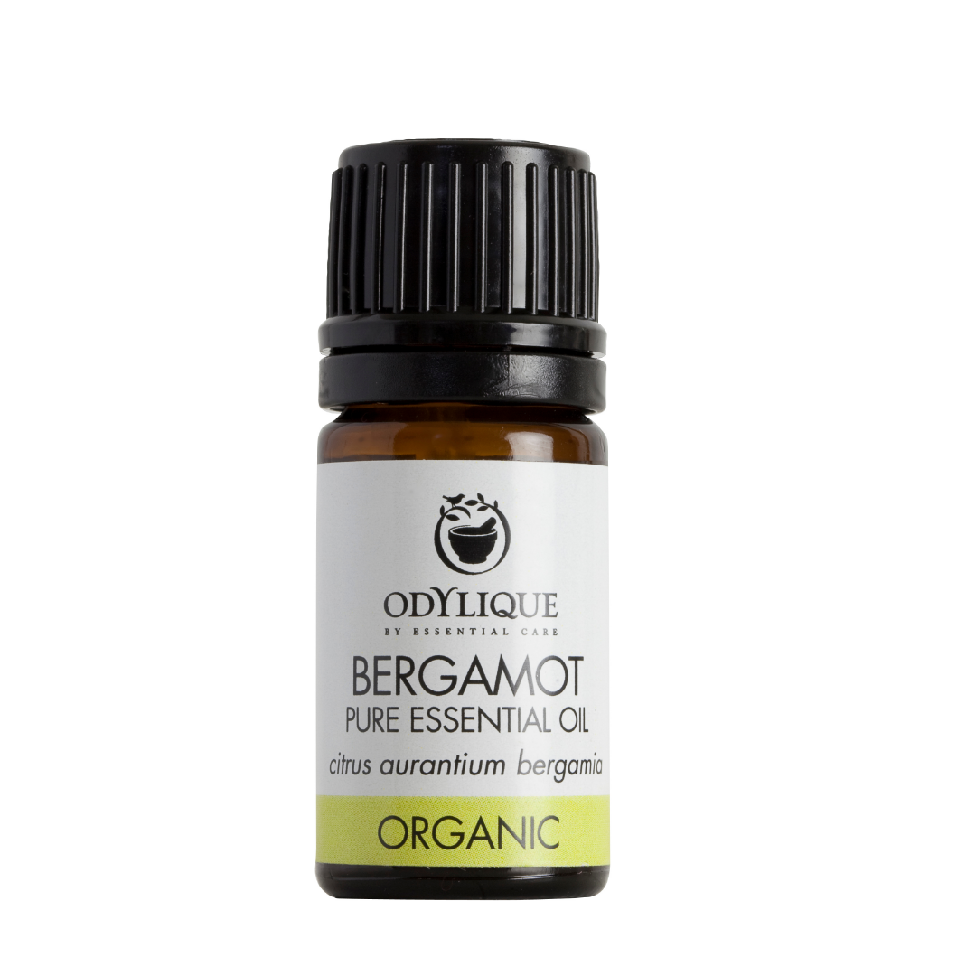 An amber glass dropper bottle of odylique Bergamot pure essential oil