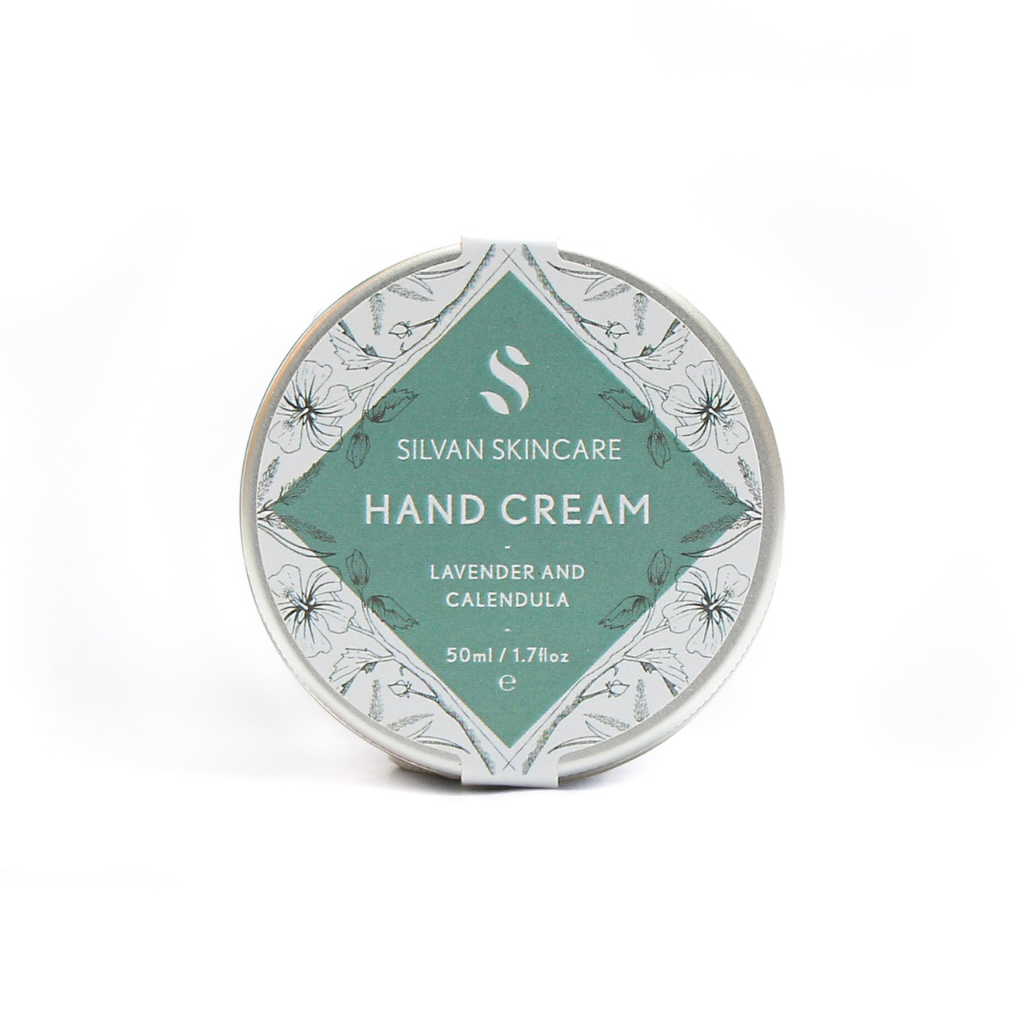 Lavender and calendula handcream photographed on a white background. the natural, vegan and cruelty free hand cream is shown in a silver coloured tin with a white and muted turquoise label on it that reads silvan skincare hand cream lavender and calendula