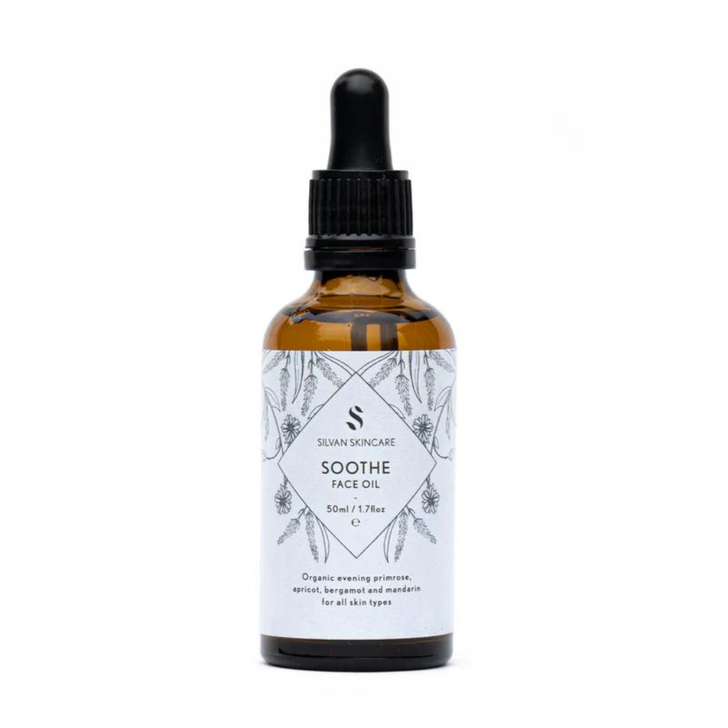 Silvan Skincare Soothe face oil in an amber glass bottle with a light blue label and black text listing the product and brand. The label also has light black botanical illustrations.
