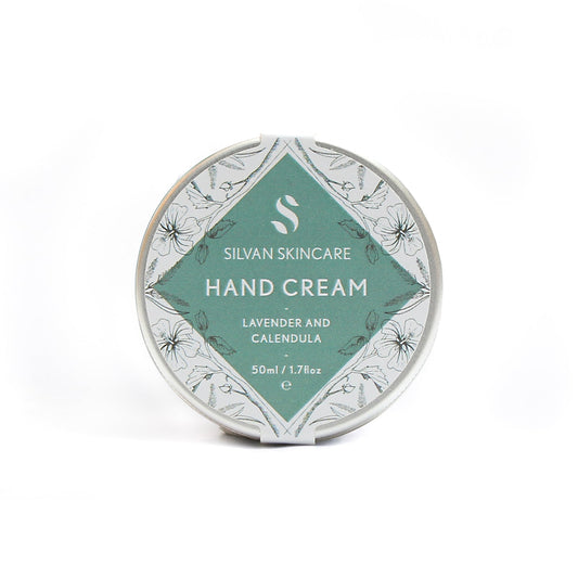 Lavender and calendula handcream photographed on a white background. the natural, vegan and cruelty free hand cream is shown in a silver coloured tin with a white and muted turquoise label on it that reads silvan skincare hand cream lavender and calendula 