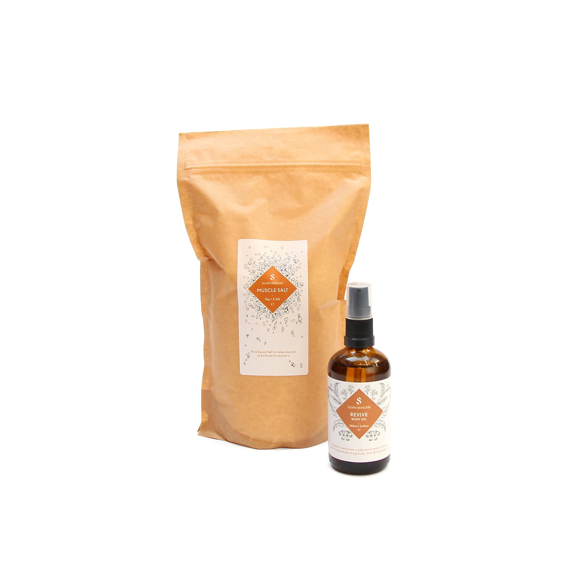A brown bag of the muscle salt and the revive Body oil placed in front of it, slightly to the left. Both items are have a white label and an orange diamond in the middle, listing the product and brand name.