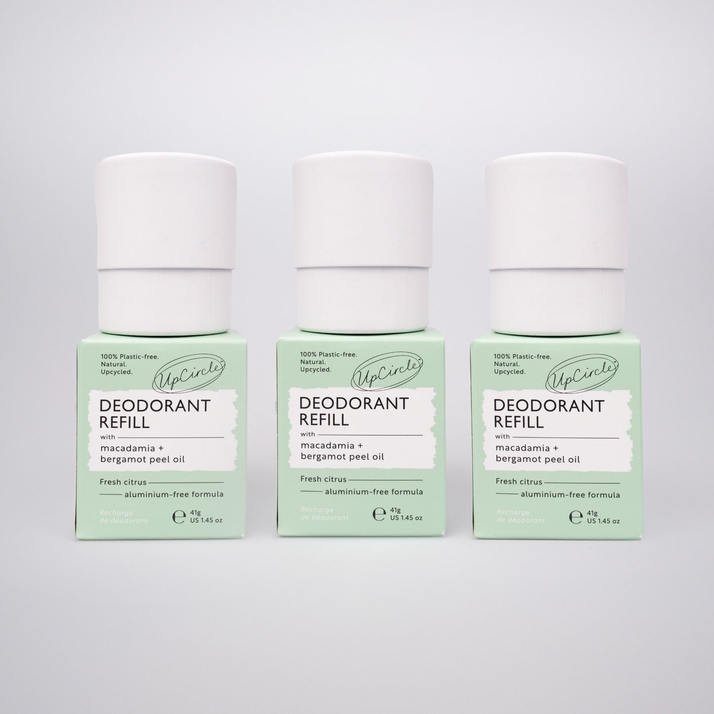 trio of upcircle deodorant refill tubes sitting on top of their green outer boxes