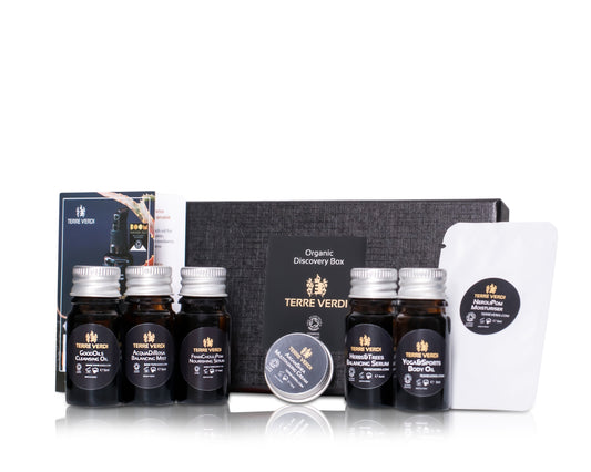 luxurious black gift box filled with miniature organic skincare samples to try in amber glass bottles with aluminium lids