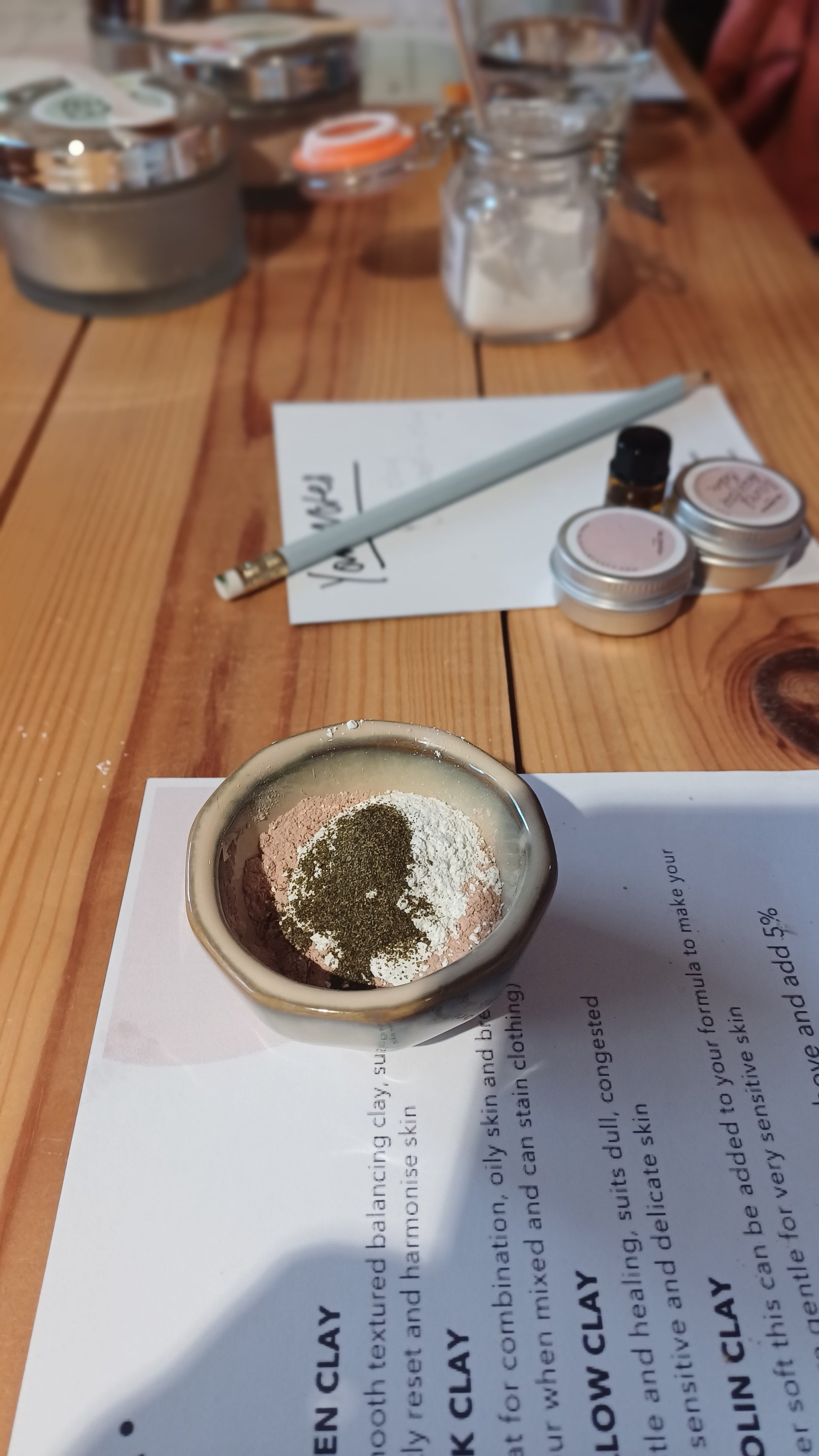 a hexagonal shaped ceramic bowl with powdered clay face mask inside it