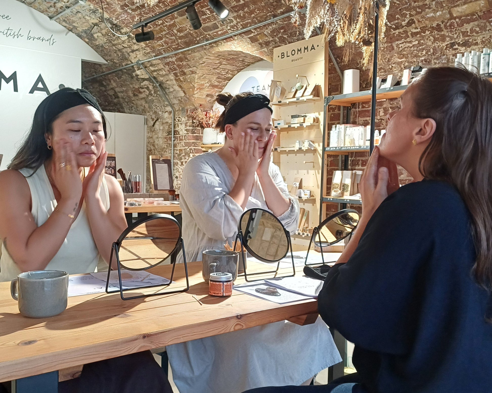 2 guests following along with the teacher a skin cleansing routine before the gua sha massage demonstration