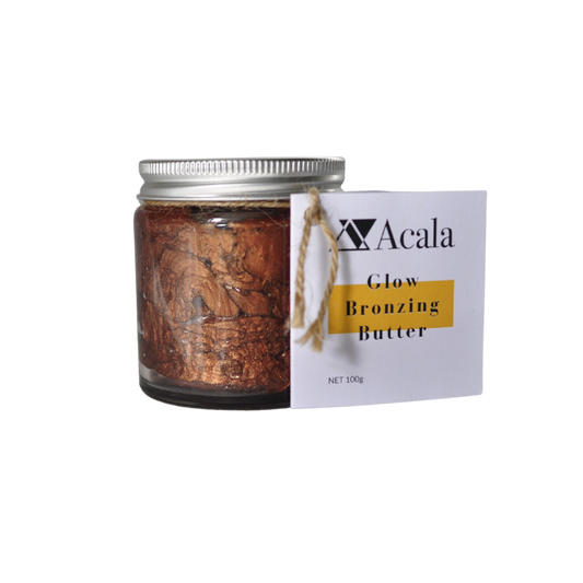photo of acala zero waste's glow bronzing butter on a transparent back ground. The bronzing butter shimmery brown colour can be seen through the clear glass jar with aluminium lid. there's a label attached with parcel string that reads acala glow bronzing butter net 100g. Alternative to self tan