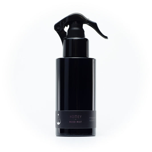 black pump spray bottle with natural room and pillow spray on a white background