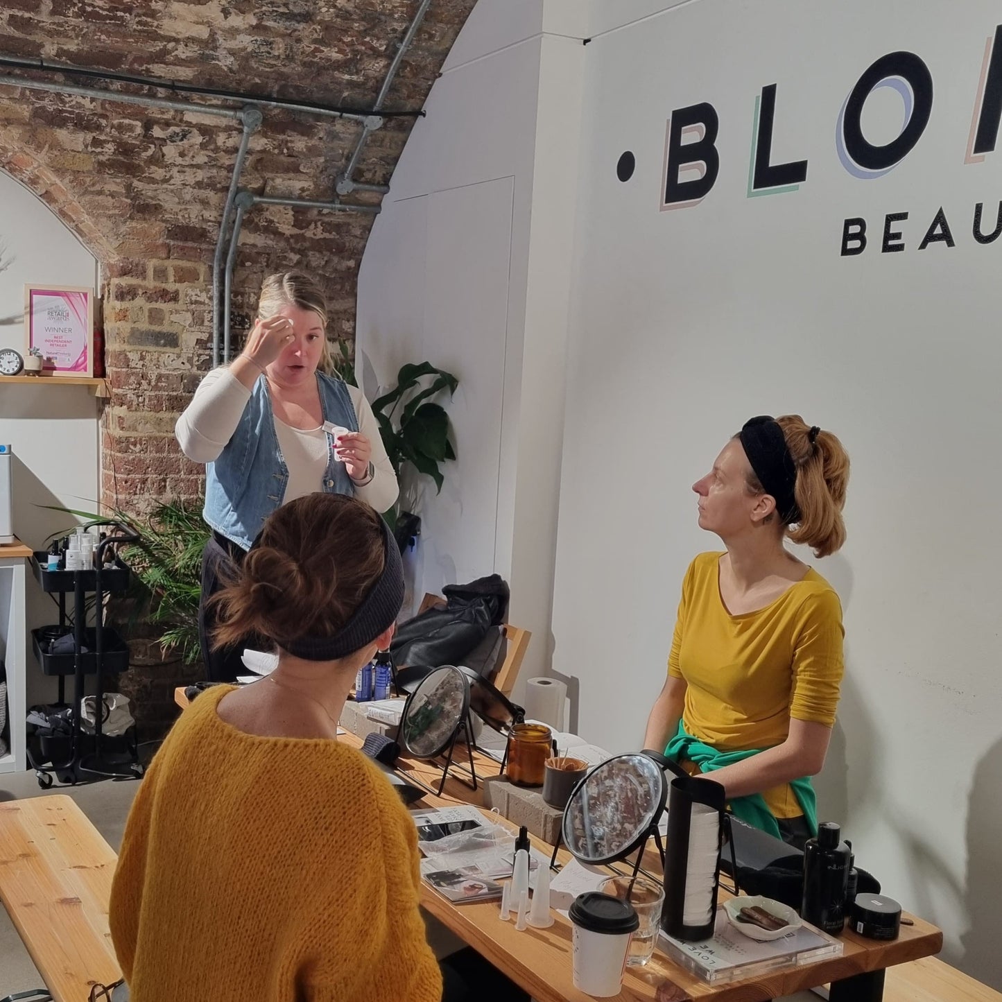 teacher demonstrating facial cupping techniques at one of blomma beauty's natural skincare classes in london
