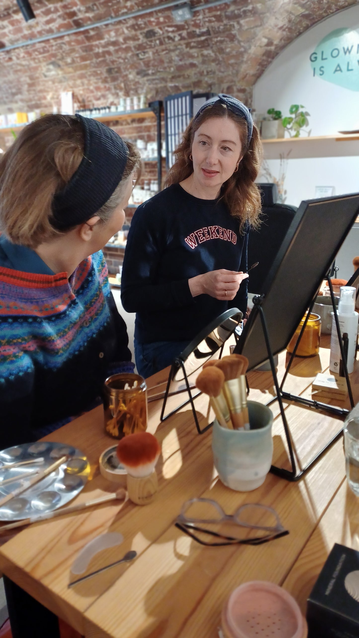 a mother and daughter looking at each other during their make up class workshop in london