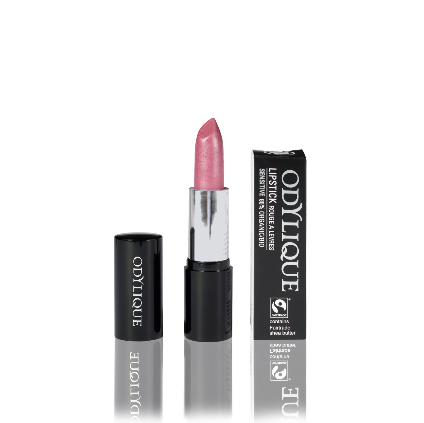 Odylique lipstick in Marshamallow (translucent frosted candy pink) partially twisted up from its black tube, positioned next to its packaging on a reflective surface.