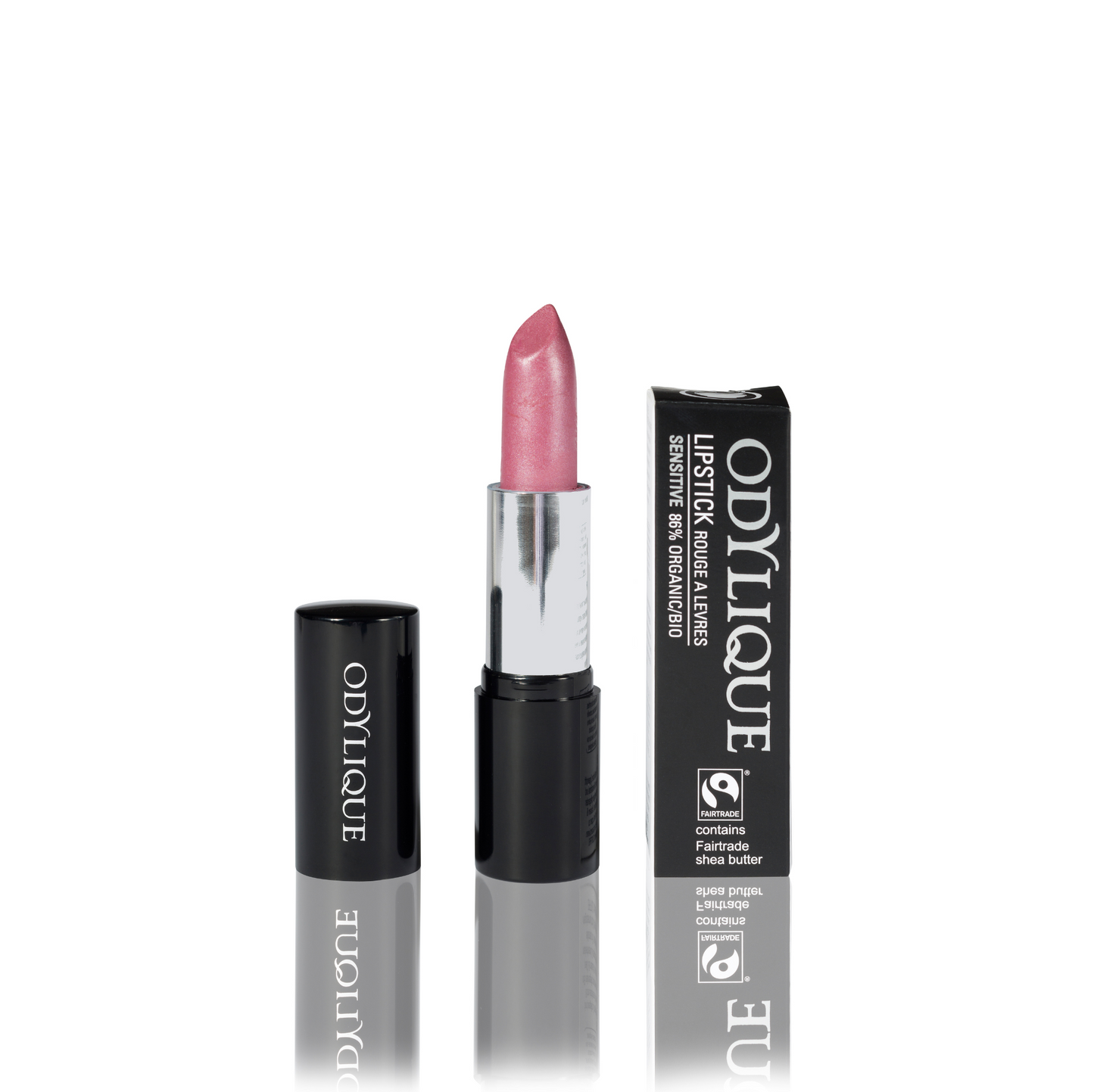Odylique lipstick in Marshamallow (translucent frosted candy pink) partially twisted up from its black tube, positioned next to its packaging on a reflective surface.
