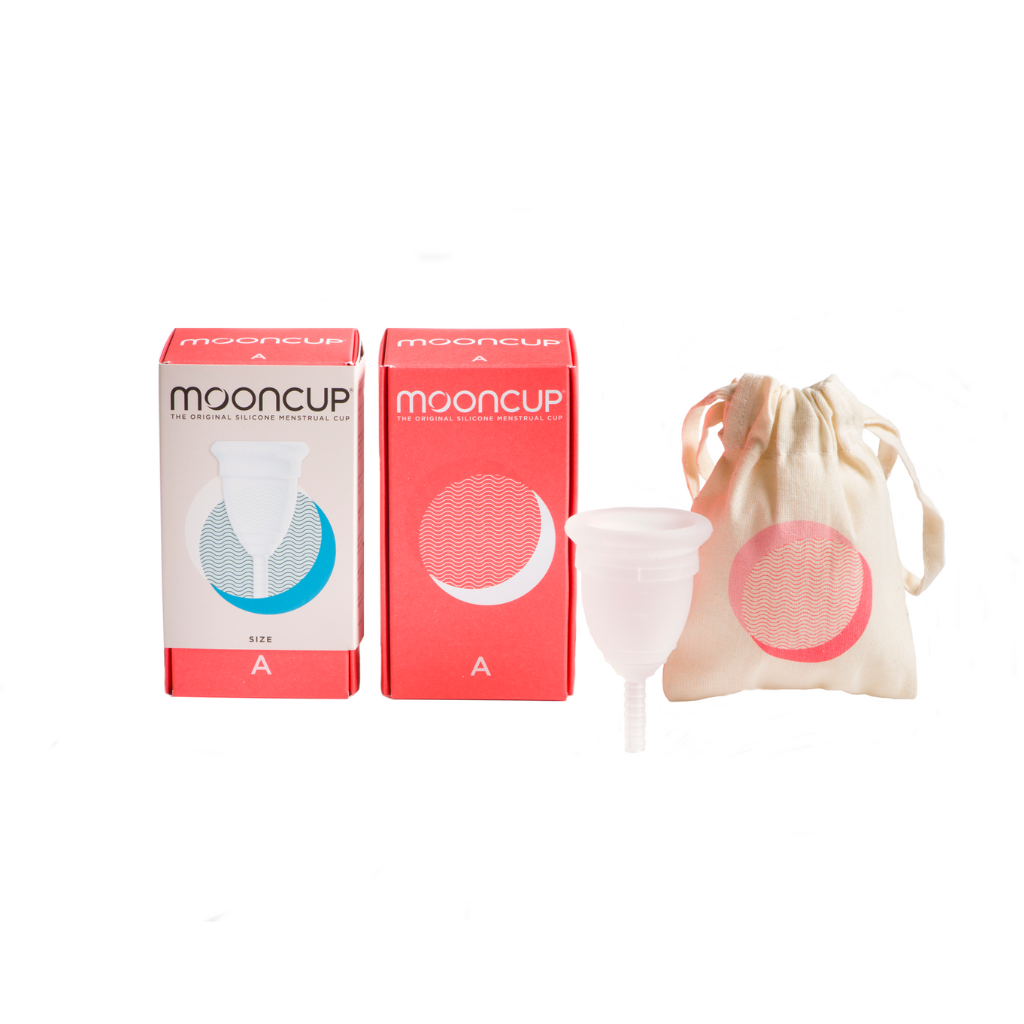 The image shows two cardboard boxes labeled "Mooncup" with a menstrual cup illustration, one bag, and a menstrual cup on display. The boxes are red and white, and a cloth drawstring bag holds one menstrual cup. The packaging also features a crescent moon design.