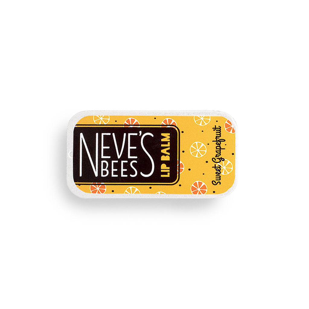 photo of a flat rectangular aluminium tin filled with sweet grapefruit beeswax lip balm. the tin has an orange yellow label and yellow and orange grapefruits drawn on it.
