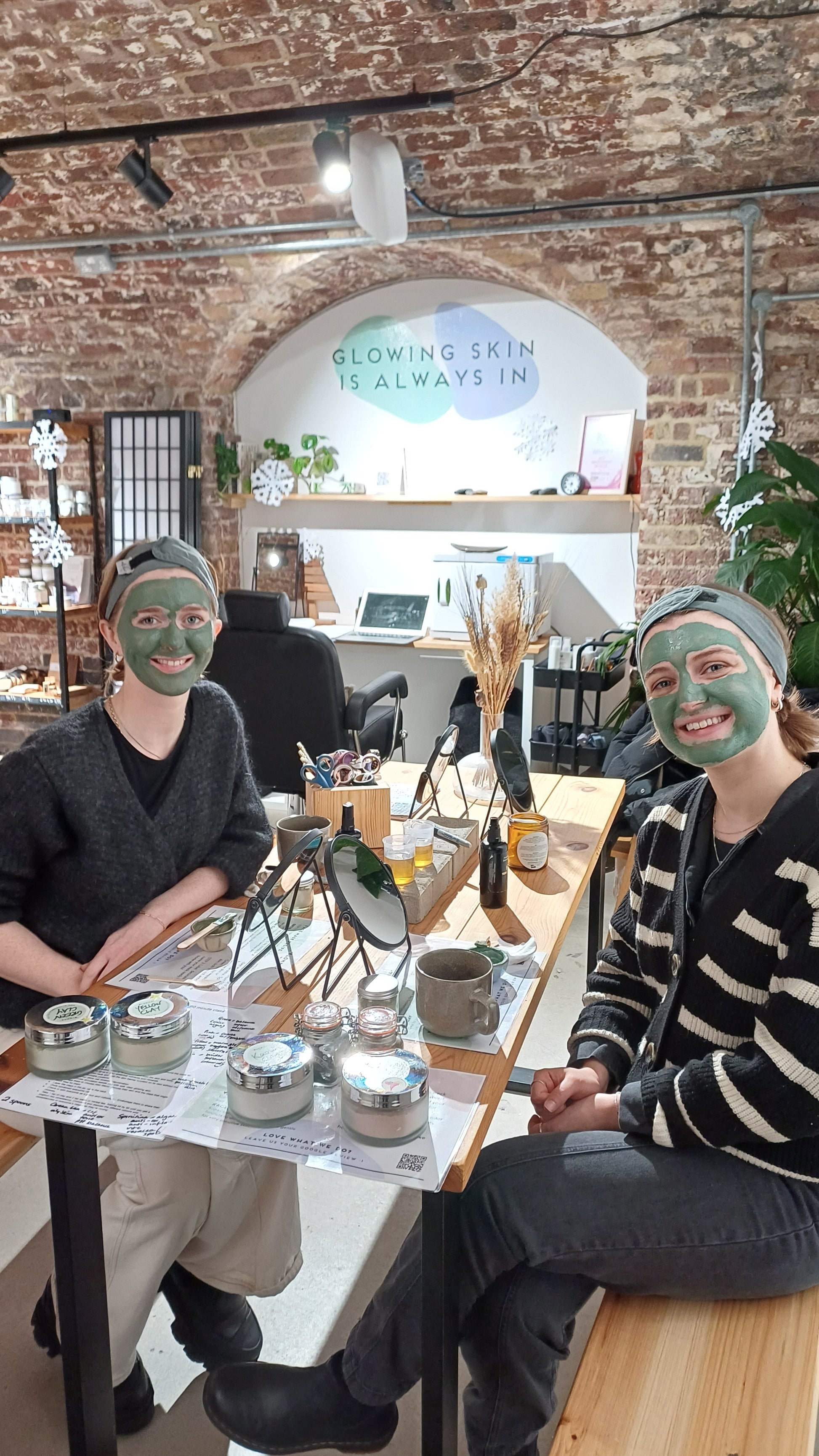 2 friends with clay face masks on their skin
