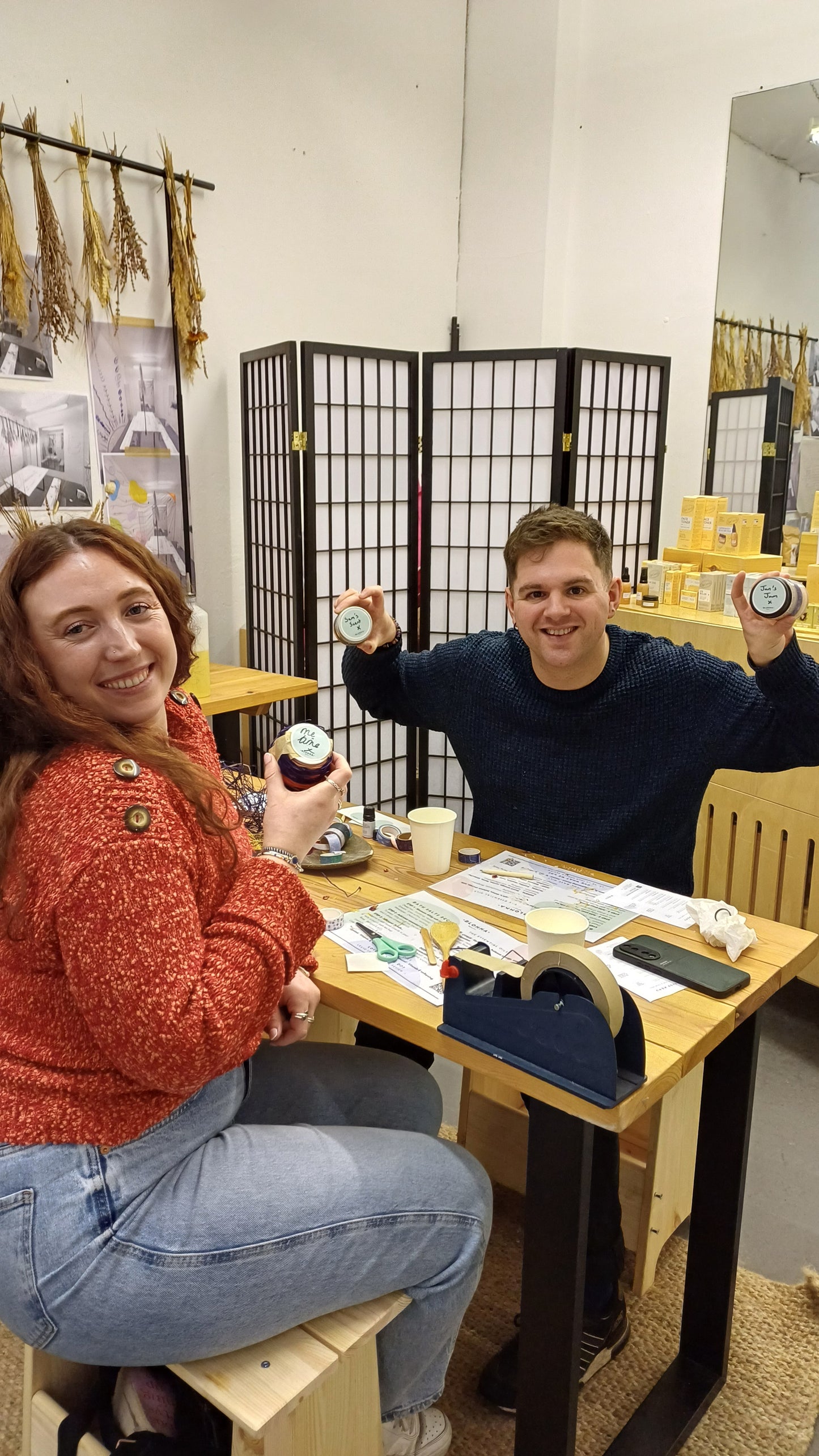 a man and a woman in the blomma beauty skincare workshop studio with their finished hand made and decorated bath salts