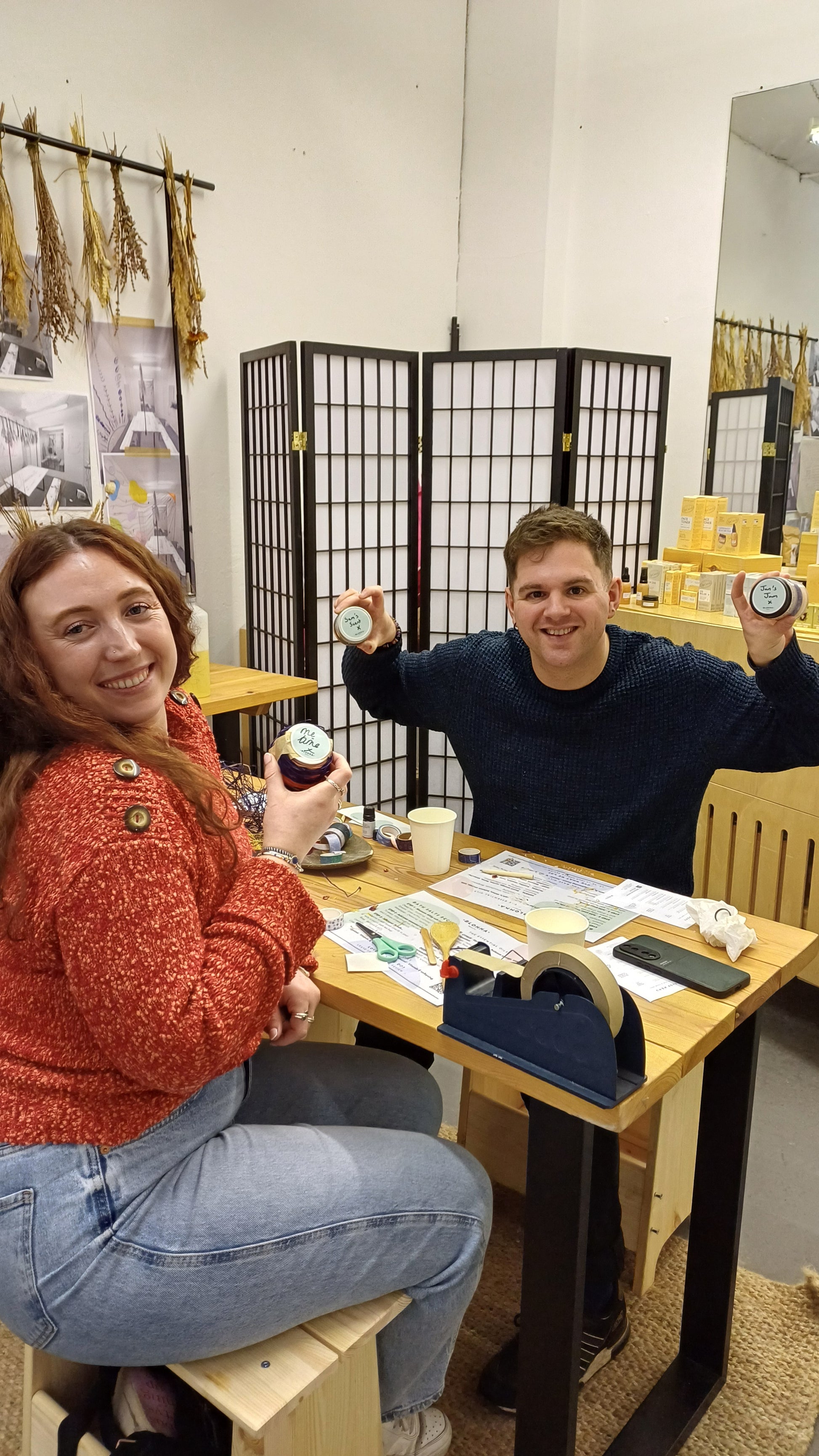 a man and a woman in the blomma beauty skincare workshop studio with their finished hand made and decorated bath salts