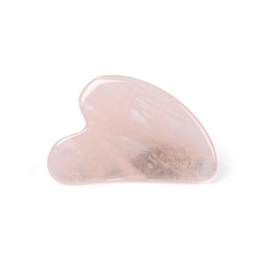 heart shaped gua sha facial massage tool on a white background. in the right hand bottom corner you can see the silvan skincare name and logo is etched in to the stone
