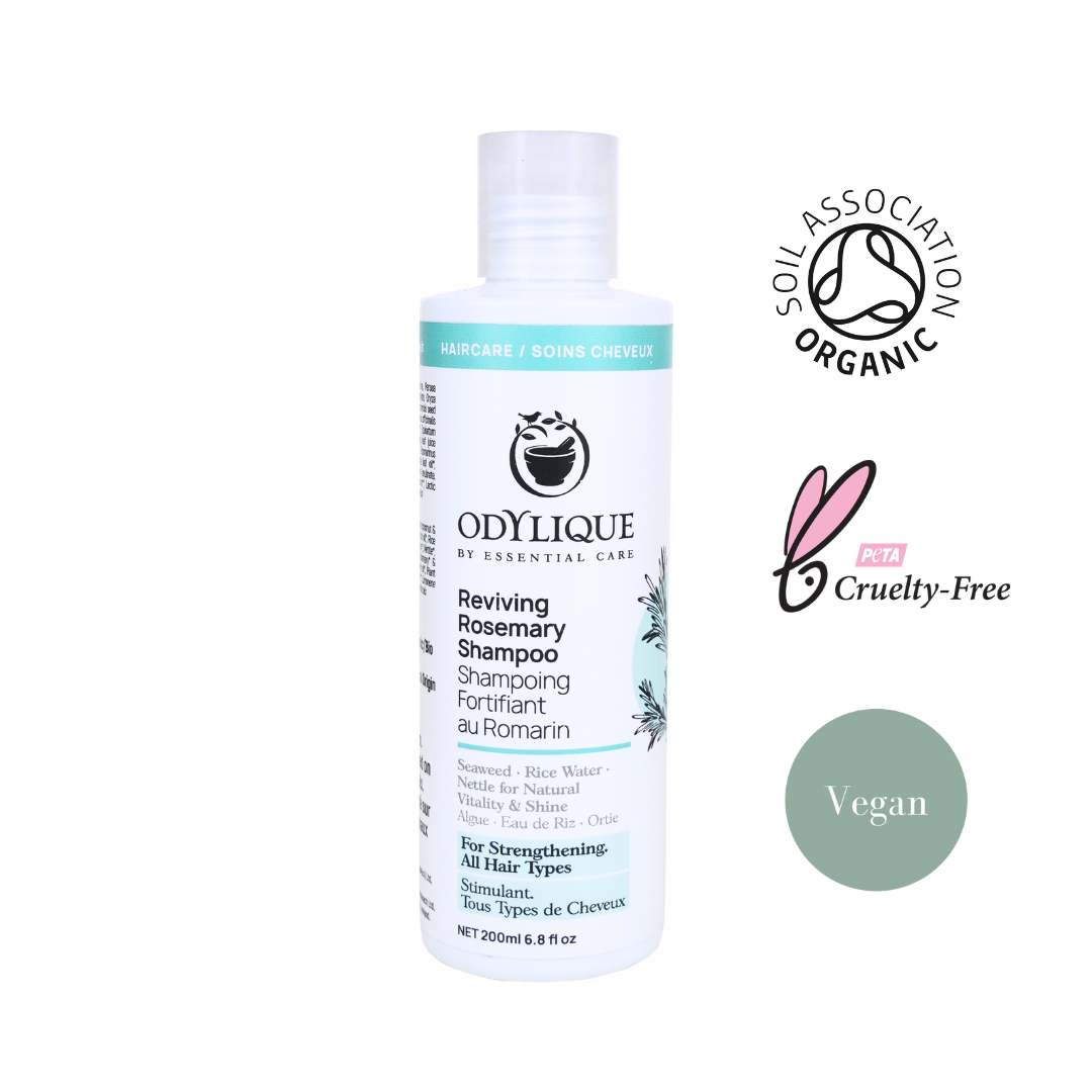 white shampoo bottle with teal accents showcase odylique's rosemary shampoo with organic, cruelty free and vegan logos along the right hand side