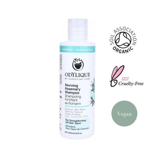 white shampoo bottle with teal accents showcase odylique's rosemary shampoo with organic, cruelty free and vegan logos along the right hand side