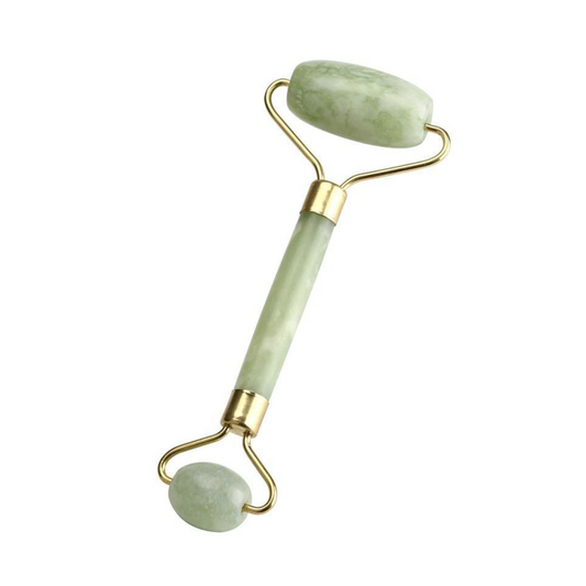 image of a green jade facial roller on a white background. the roller is double ended with gold metal accents and an oblong roller stone at one end and a smaller rounder one at the other end for massaging the face and around the eyes