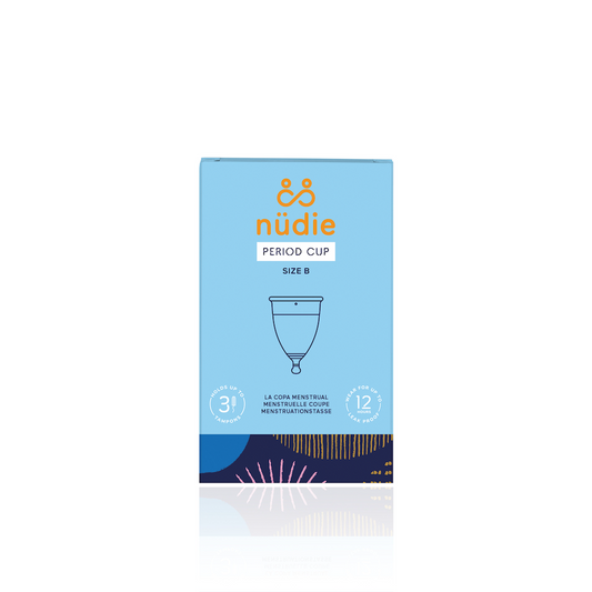 & Sisters Nudie Period Cup. Sustainable period care. The blue paper box that holds the B cup is shown, with a drawing of the cup and the nudie logo in gold.