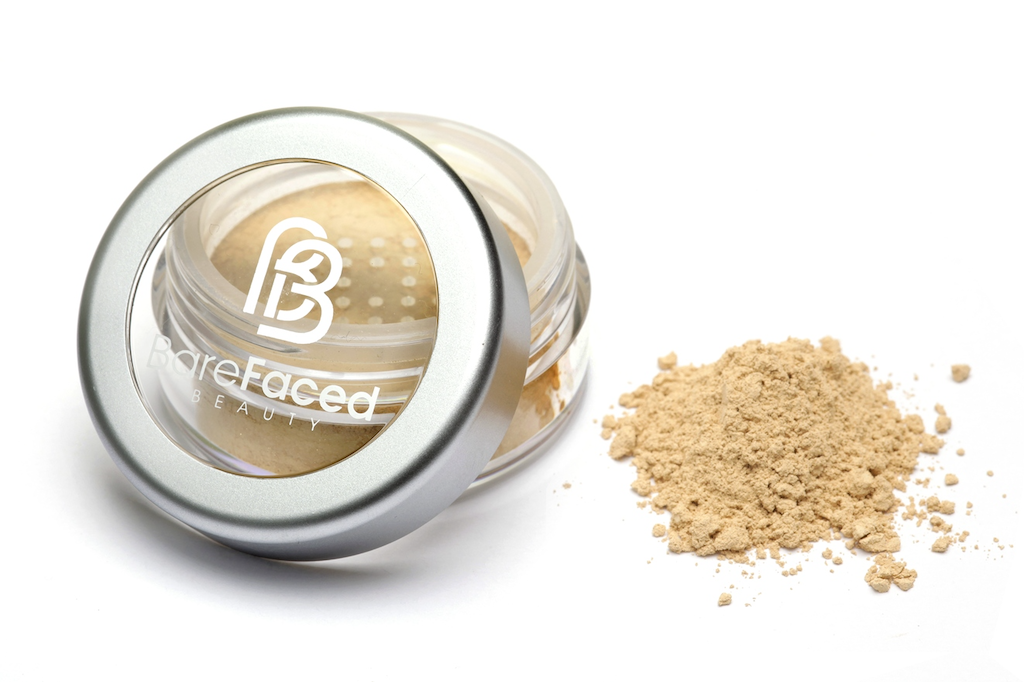 BareFaced Beauty Natural Mineral Foundation in Gracious. Ethical mineral makeup. The powder mineral foundation is pictured in a clear plastic jar with a small pile of the powder sitting next to it.