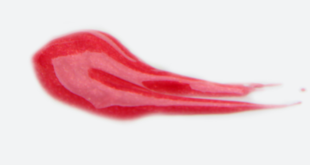 BareFaced Beauty Natural Mineral Lip Gloss in Arresting. Natural lip gloss. A dollop of gloss is spread on a white surface. The shade is a bright red.
