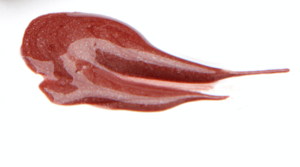 BareFaced Beauty Natural Mineral Lip Gloss in Breathtaking. Natural lip gloss. A dollop of gloss is spread on a white surface. The shade is a glittery reddish brown