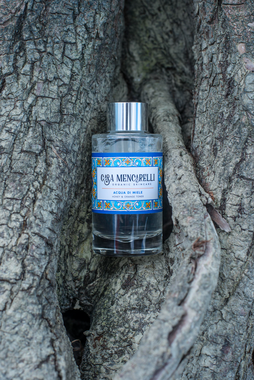 Casa Mencarelli Acqua di Miele Honey & Orange Toner. Toner for sensitive skin. The toner bottle is pictured inside some tree roots.