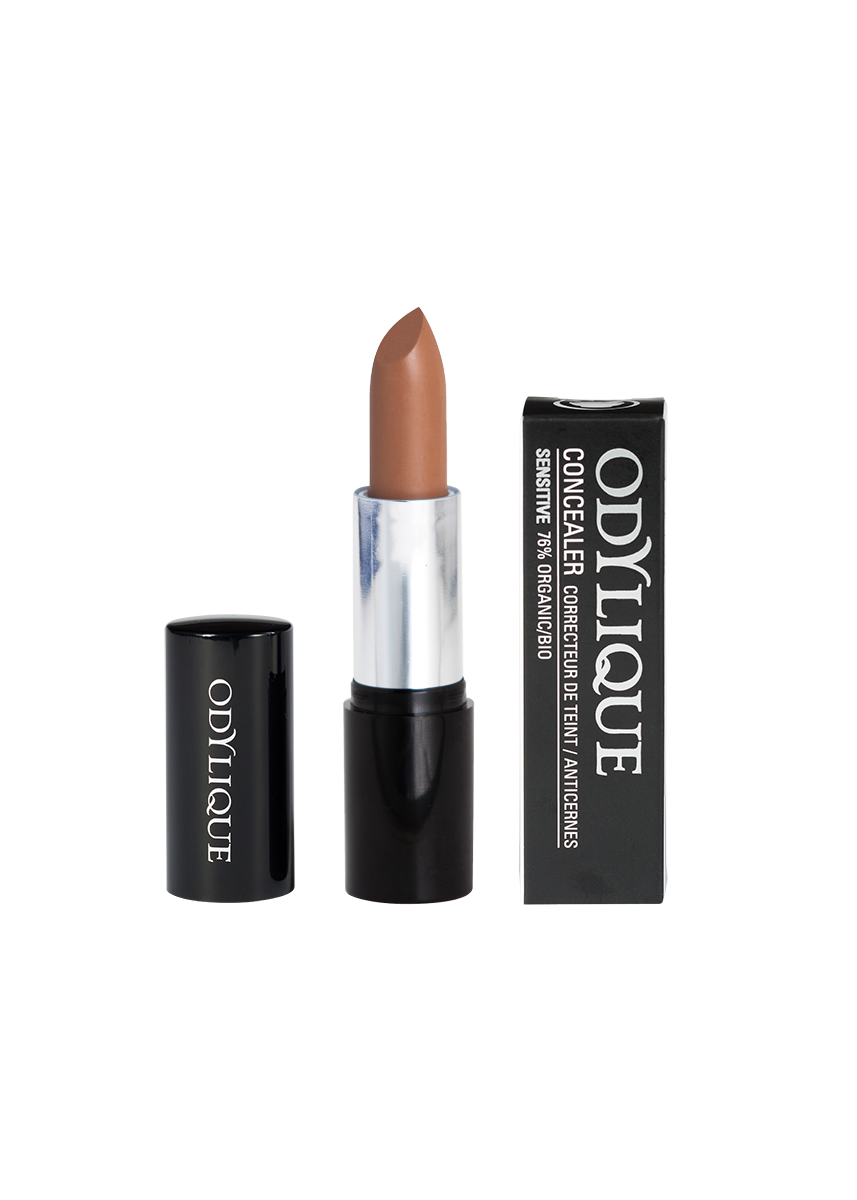 A single tube of the Odylique Dark concealer with the cap removed, revealing a deep olive shade concealer shade, set against a plain white background.