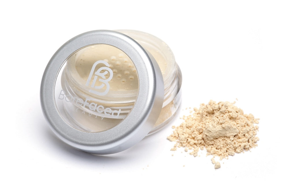 BareFaced Beauty Natural Finishing Powder in Jasmine. Ethical mineral makeup. The powder mineral foundation is pictured in a clear plastic jar with a small pile of the powder sitting next to it.