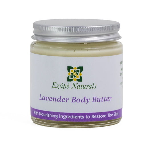 lavender body butter which is handmade by ezape naturals is photographed on a white background. the body cream comes in a clear glass jar with a silver aluminium lid. the label is white with a lavender coloured band along the bottom and reads ' ezape naturals lavender body butter with nourishing ingredients to restore the skin'
