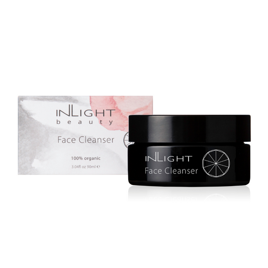 inlight beauty 100% organic face cleanser in a black glass jar with a black plastic lid. sitting next to the box which is white with grey and pink blush tones splashed across it on a white background.