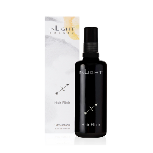 inlight beauty 100% organic blend of oils for healthy, breakage free, smooth, strong hair. photographed on a white background with the light grey, white and yellow box sitting behind the black bottle of hair oil