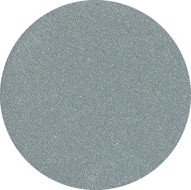 Close-up swatch of single pan Odylique organic eyeshadow in shade Lagoon, a muted mid-blue with a soft sheen.